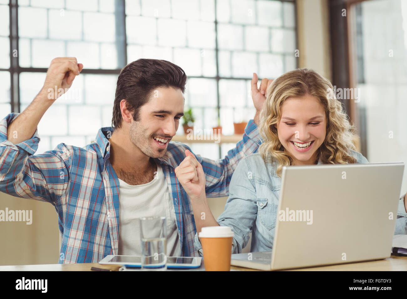 Colleagues cheering in office Stock Photo - Alamy