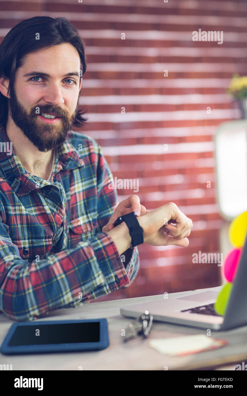 Portrait of smiling creative businessman checking time Stock Photo - Alamy