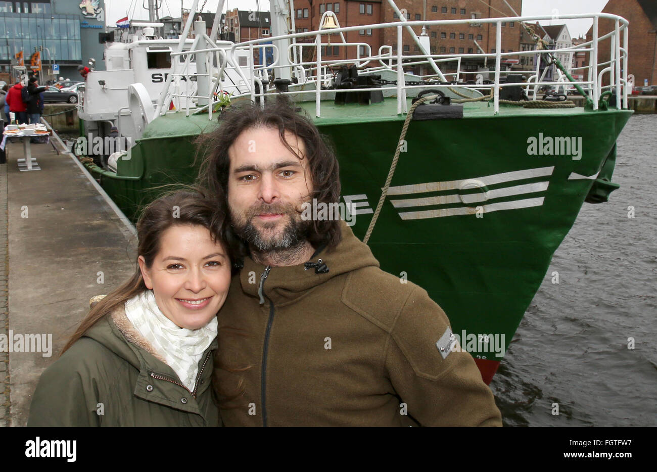 Rostock, Germany. 22nd Feb, 2016. Michael Buschheuer (R), founder of the refugee initiative 'Sea Eye, ' poses with his partner Hannelore Korduan in front of a cutter of the initiative, in Rostock, Germany, 22 February 2016. After its christening, the cutter is to head to the Mediterranean Sea to rescue refugees in distress. Credit:  dpa picture alliance/Alamy Live News Stock Photo