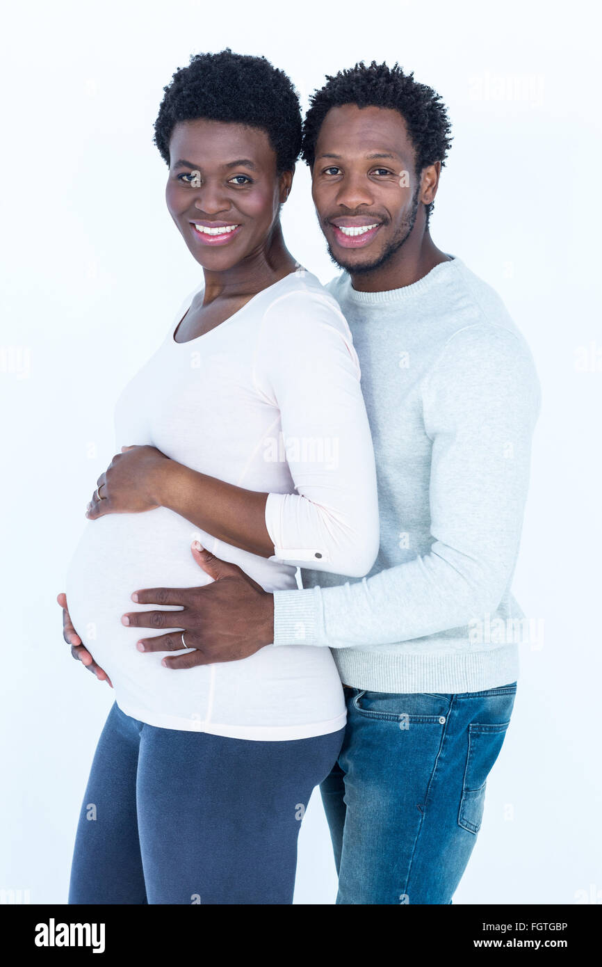 Portrait of man hugging his pregnant wife while standing Stock Photo