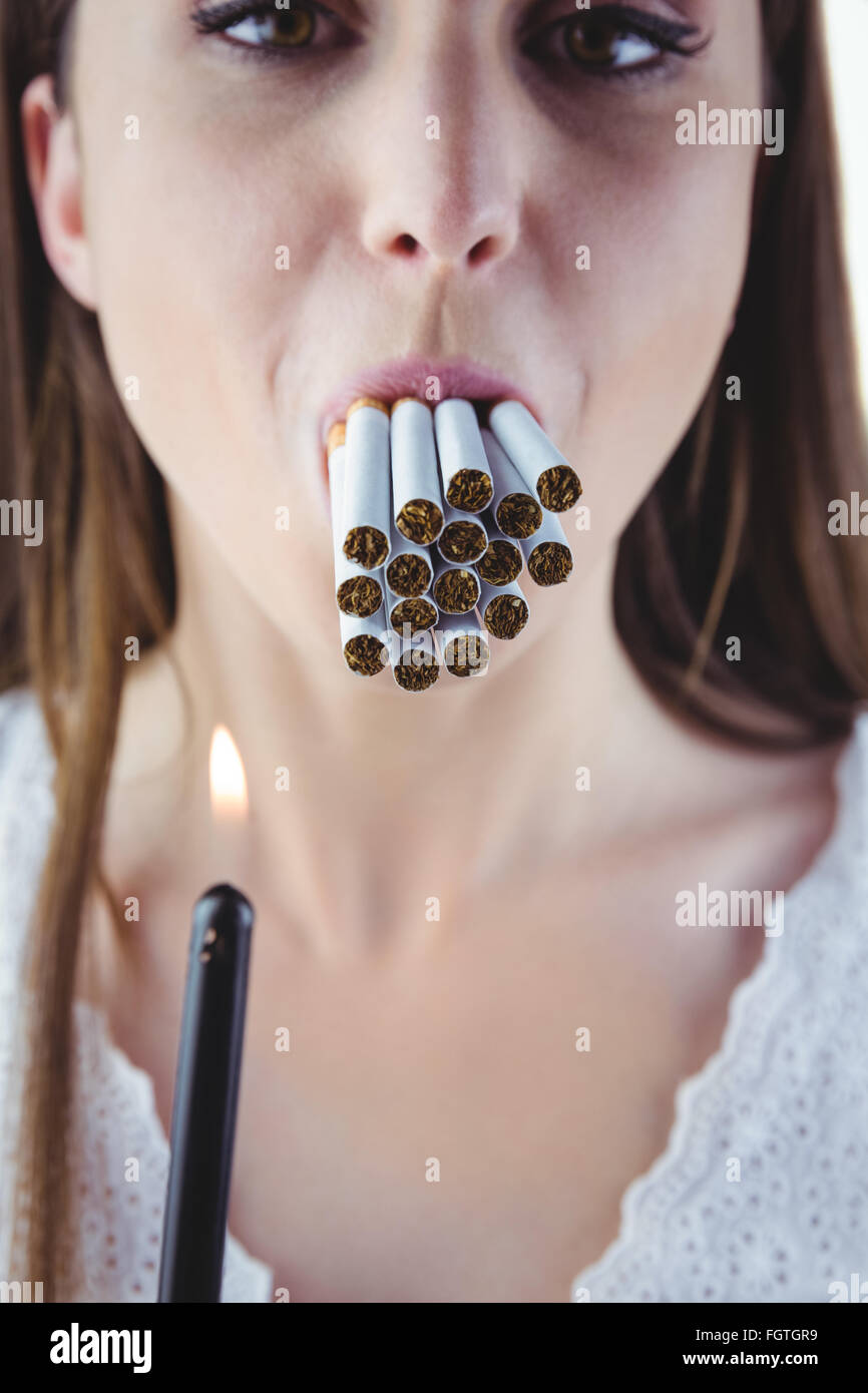 Woman lighting many cigarettes in mouth Stock Photo Alamy