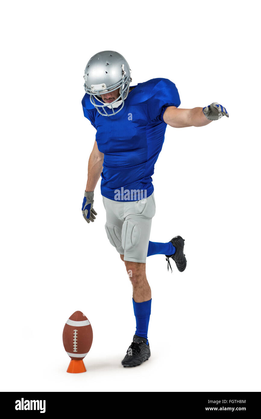 American football player kicking ball Stock Photo Alamy