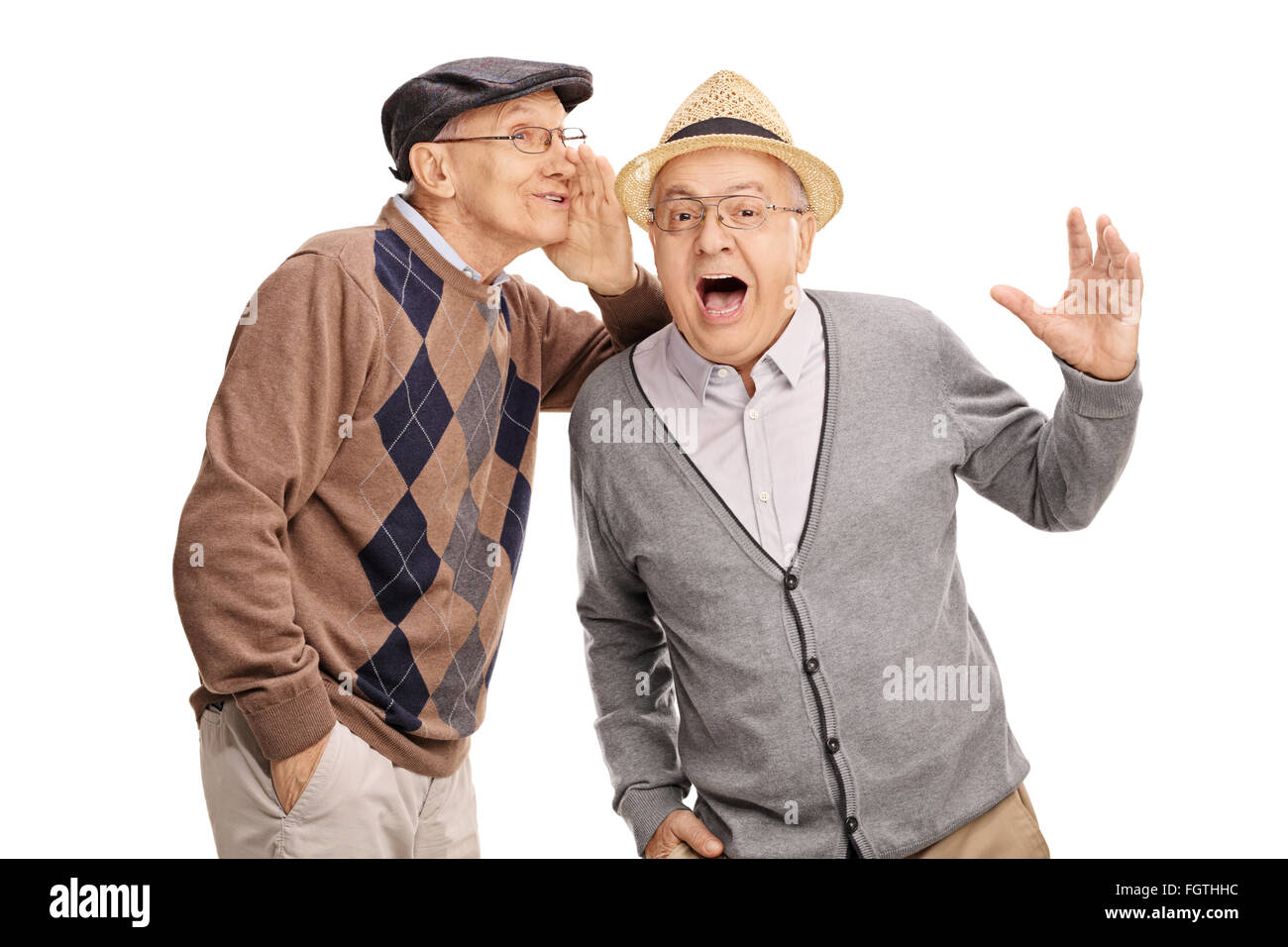 Senior man whispering something to his friend and laughing together isolated on white background Stock Photo