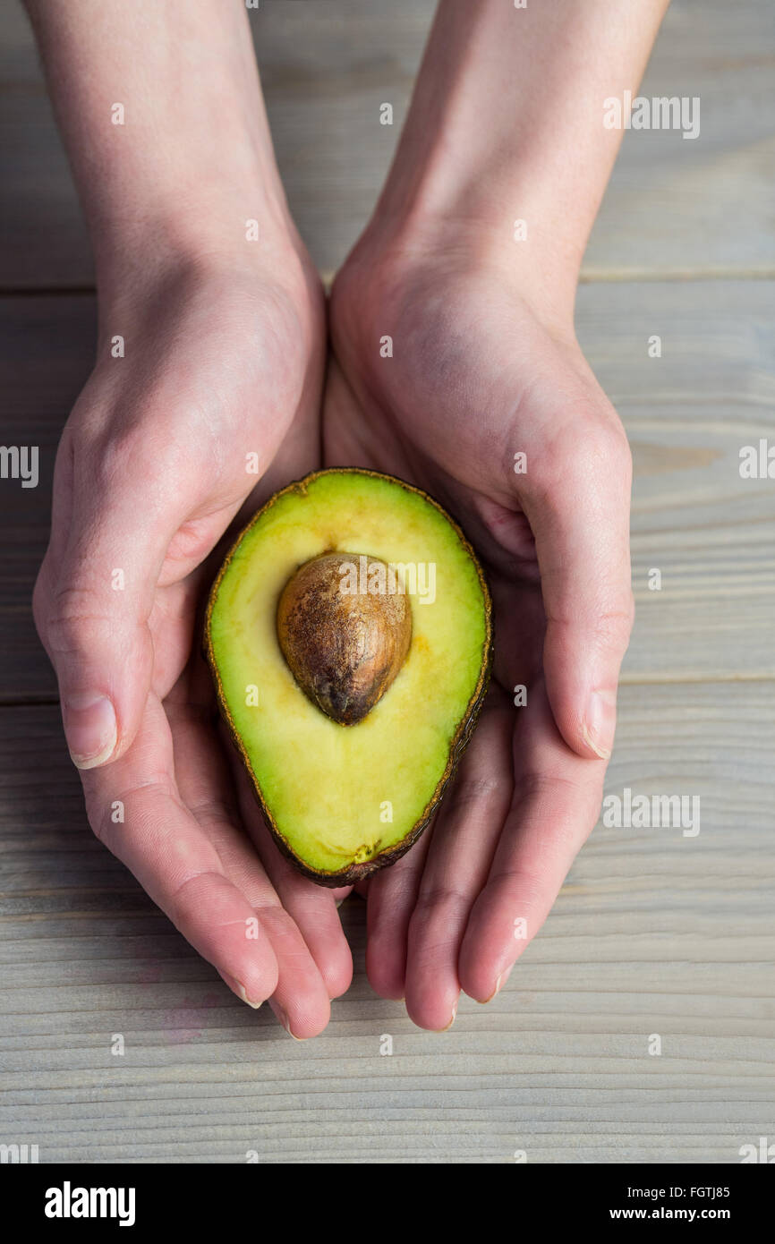 Woman showing fresh avocado Stock Photo Alamy