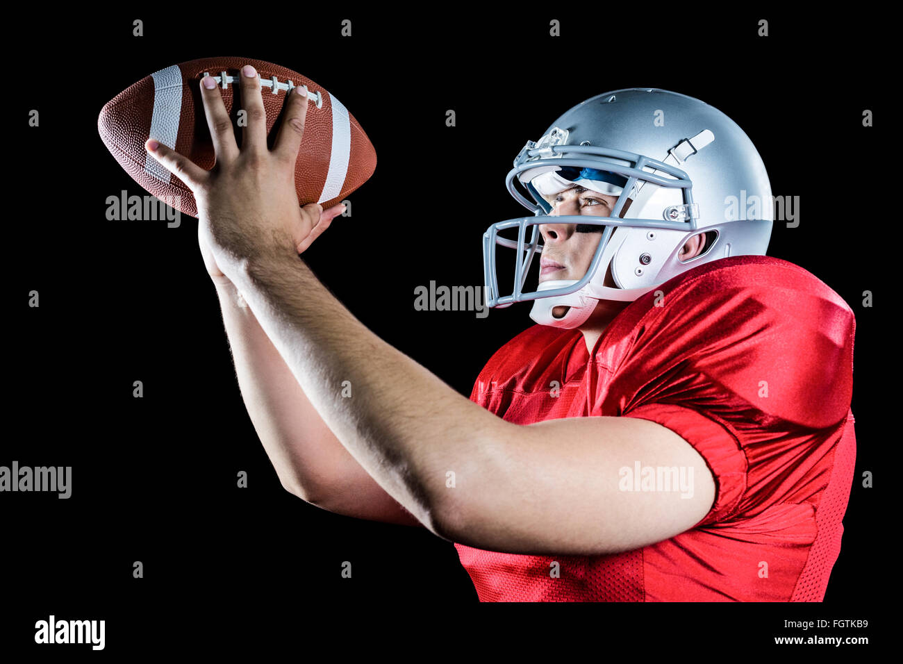 Side view of American football player throwing ball Stock Photo - Alamy