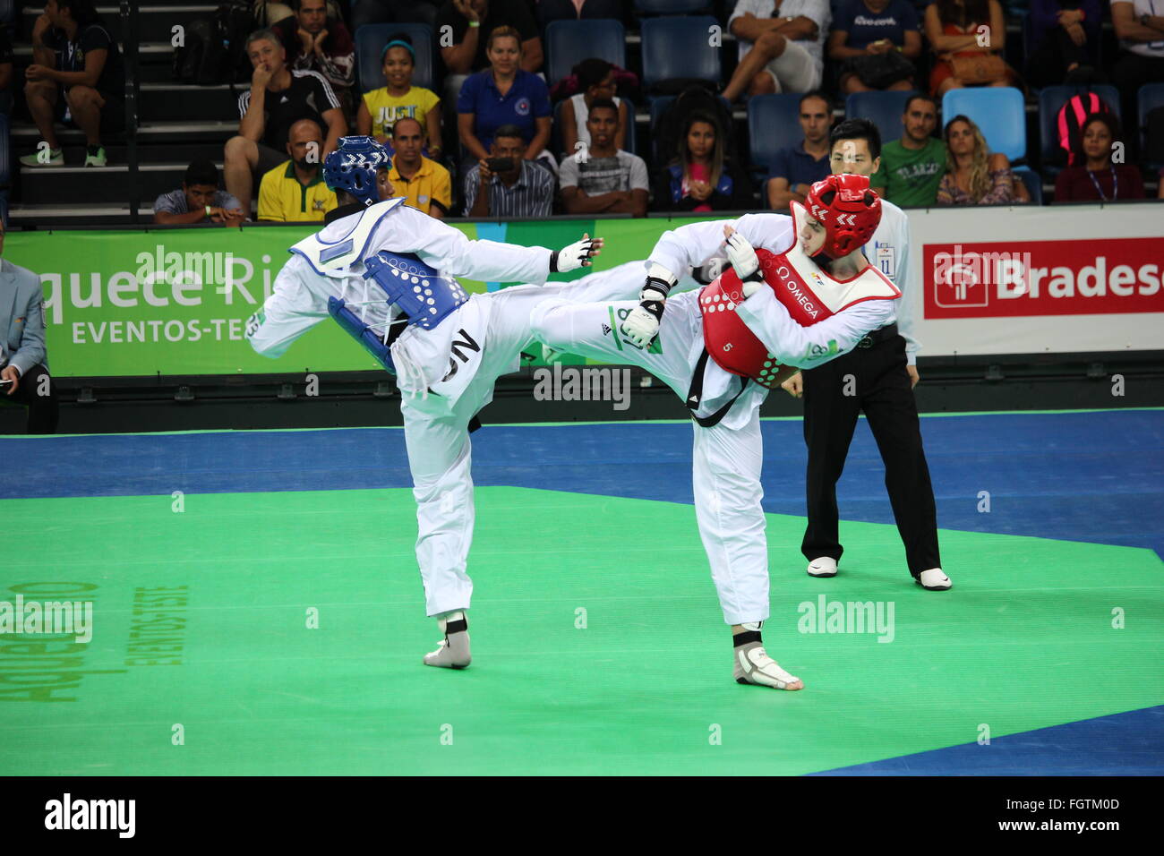 Rio de Janeiro, Brazil, 21 February 2016: Rio 2016 Olympic Park holds a test event for Rio 2016 Olympic Games. The International Taekwondo Tournament meets 64 athletes from 15 countries. Among the athletes participating in the competition are: Iris Tang Sing, Rafaela Ahmad, João Miguel Neto, Leonardo de Moraes and Andre Bilia, from Brazil, Rui Bragança from Portugal anda Mayu Yama from Japan. In this photo are the American Healy J. and the Tunisian Trabelsi Y. during the fight which ended with the American victory. Credit:  Luiz Souza/Alamy Live News Stock Photo