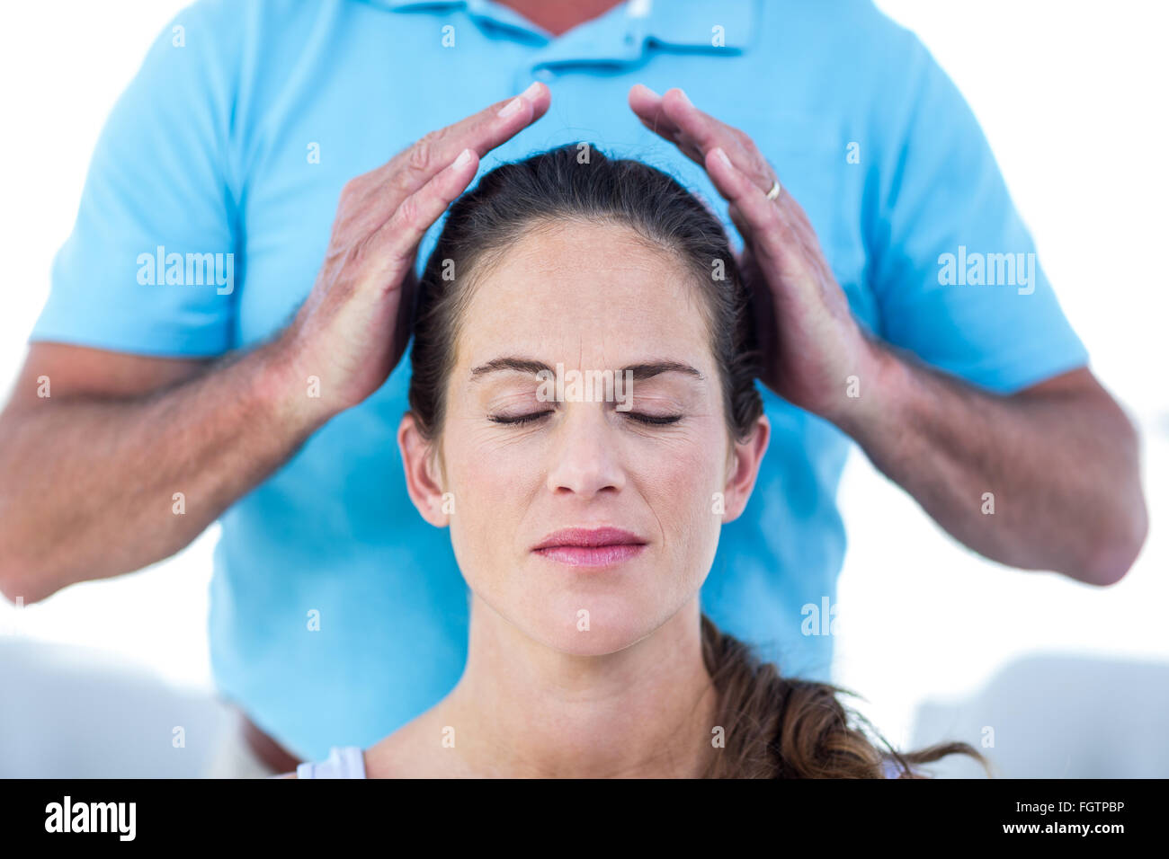 Therapist performing reiki on young woman Stock Photo - Alamy