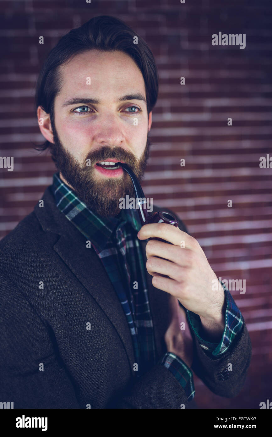Serious man with smoking pipe looking away Stock Photo - Alamy