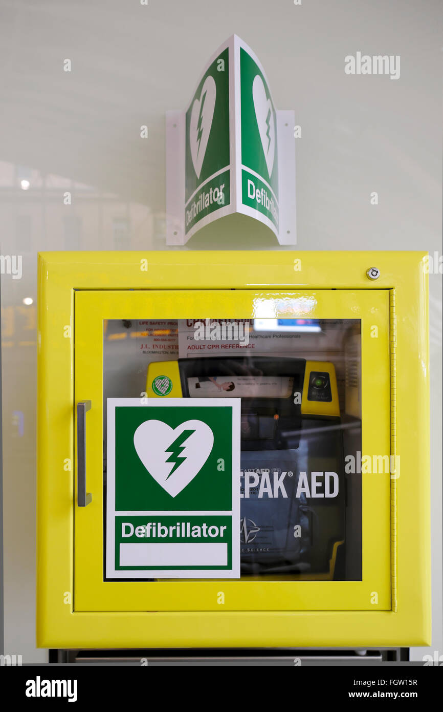 Defibrillator on a wall in public area of Kings Cross Station in London UK  KATHY DEWITT Stock Photo