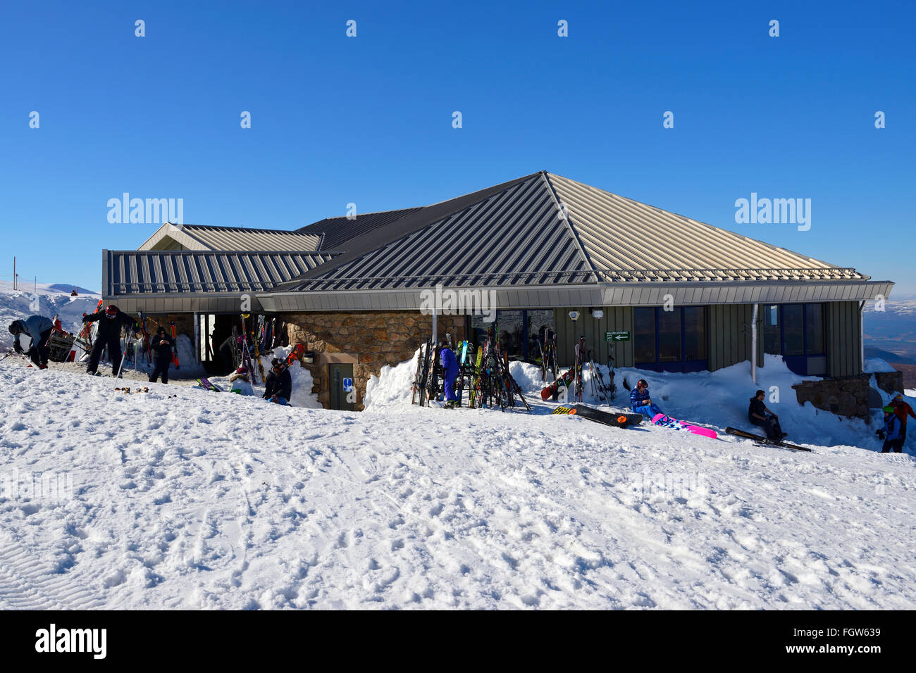 Skiers and snowboarders outside Ptarmigan Restaurant at Cairngorm Mountain Ski Centre, Aviemore, Scottish Highlands, UK Stock Photo