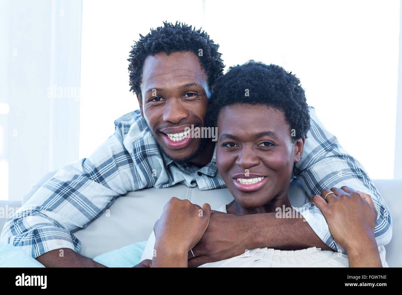 Happy couple hugging at home Stock Photo - Alamy