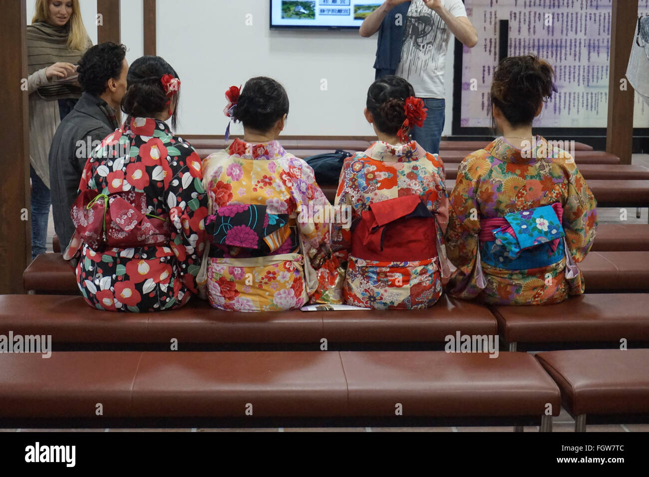 Japanese girls in traditional kimonos have their photos taken Stock Photo