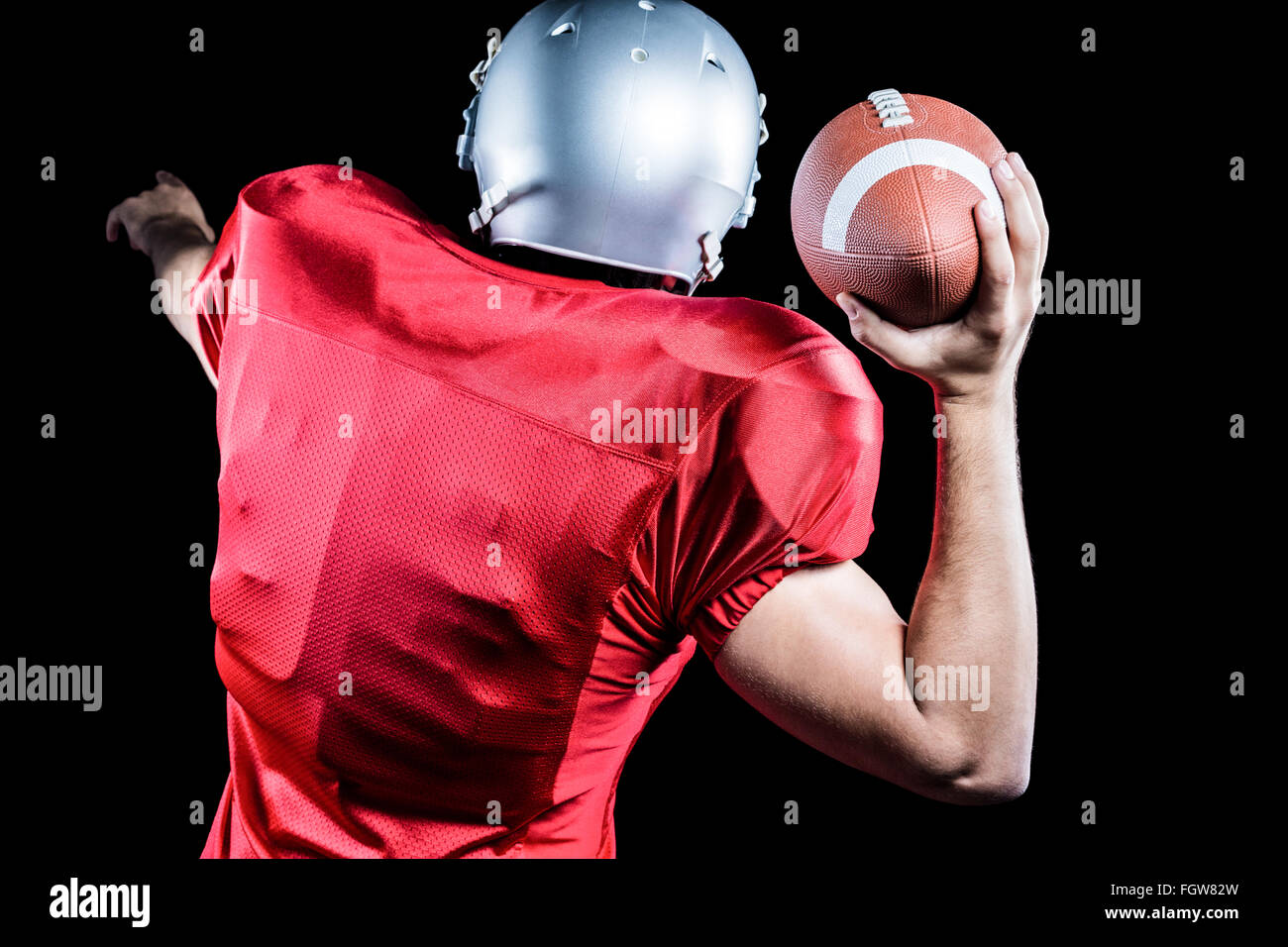 Rear view of American football player throwing ball Stock Photo Alamy