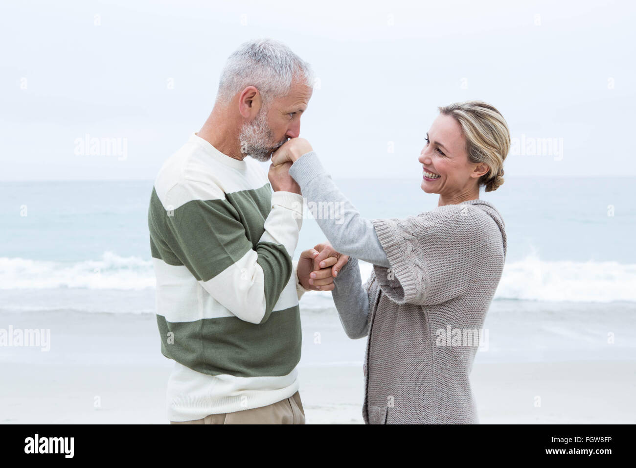 Romantic man kissing womans hand Stock Photo - Alamy