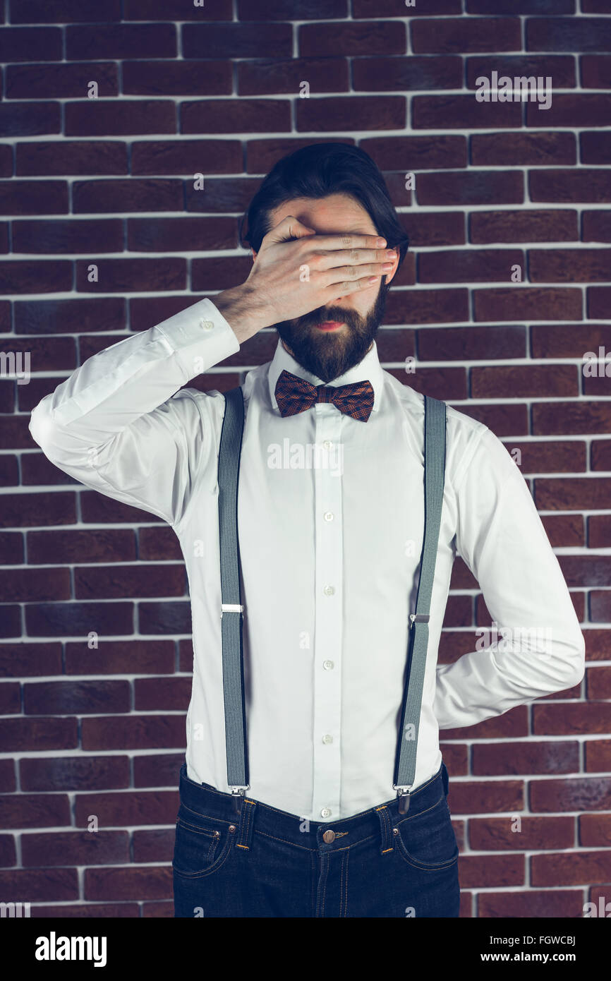 A bearded Man covering eyes Stock Photo