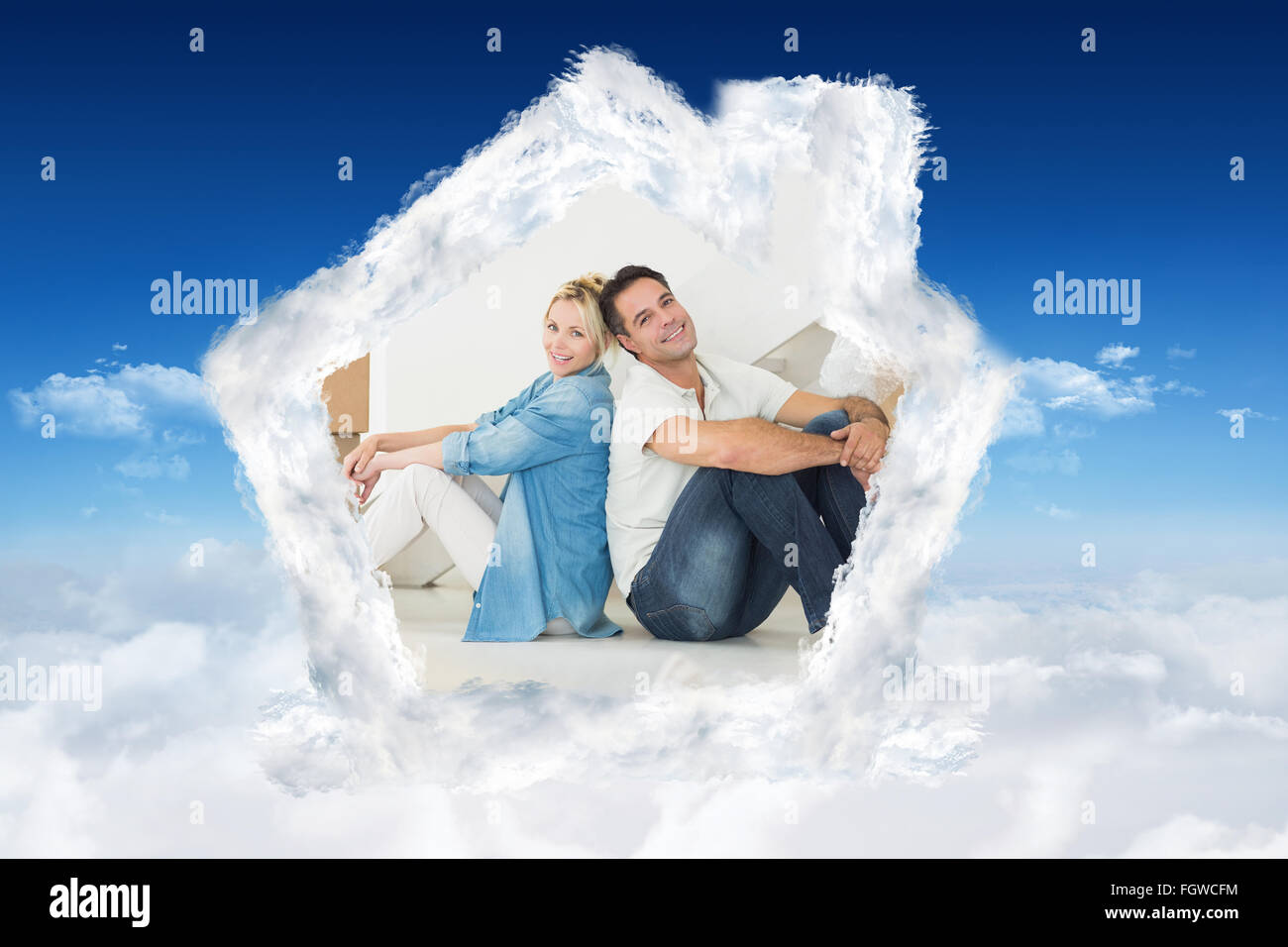 Composite image of smiling couple with boxes in a new house Stock Photo
