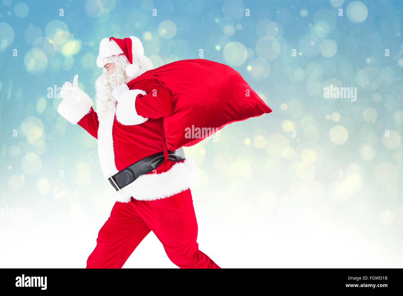 Composite image of positive santa with a sack and thumbs up Stock Photo ...