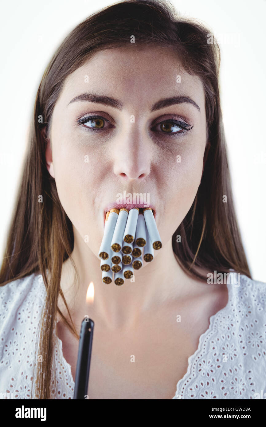 Woman lighting many cigarettes in mouth Stock Photo - Alamy