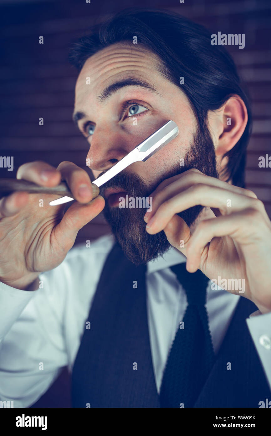A man shaving his beard Stock Photo Alamy
