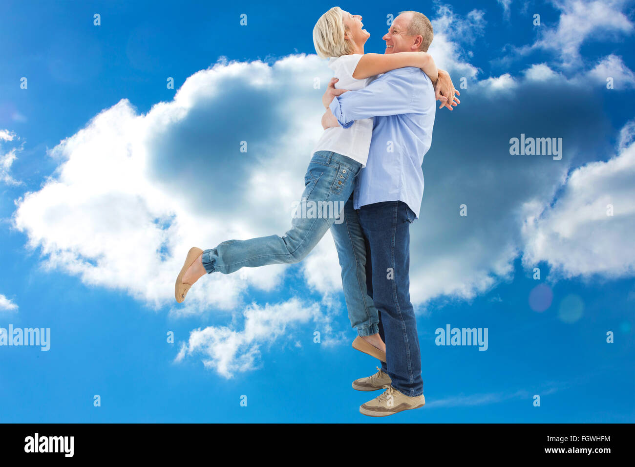 Composite image of mature couple hugging and having fun Stock Photo