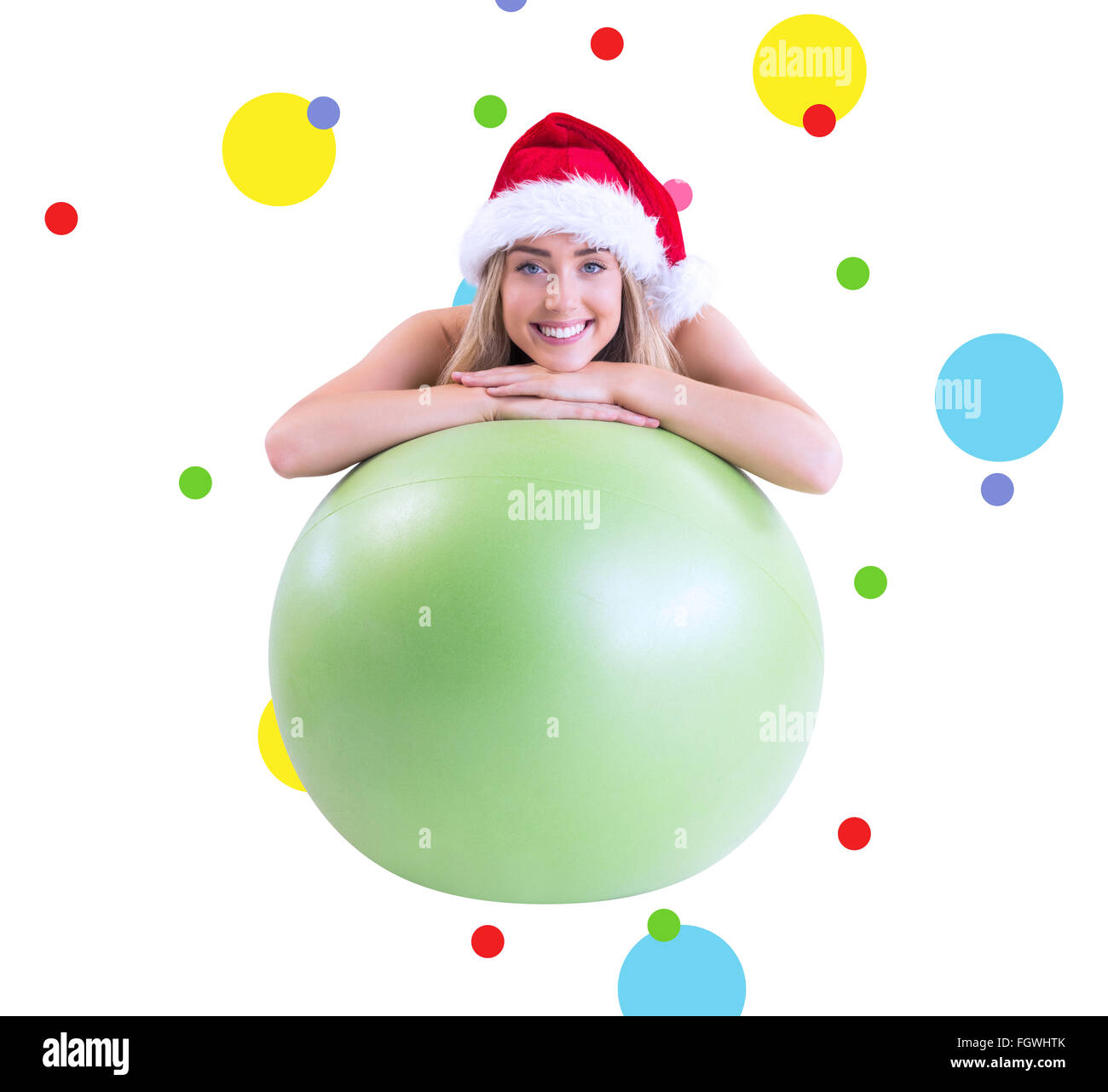 Composite image of festive fit blonde posing with exercise ball Stock Photo