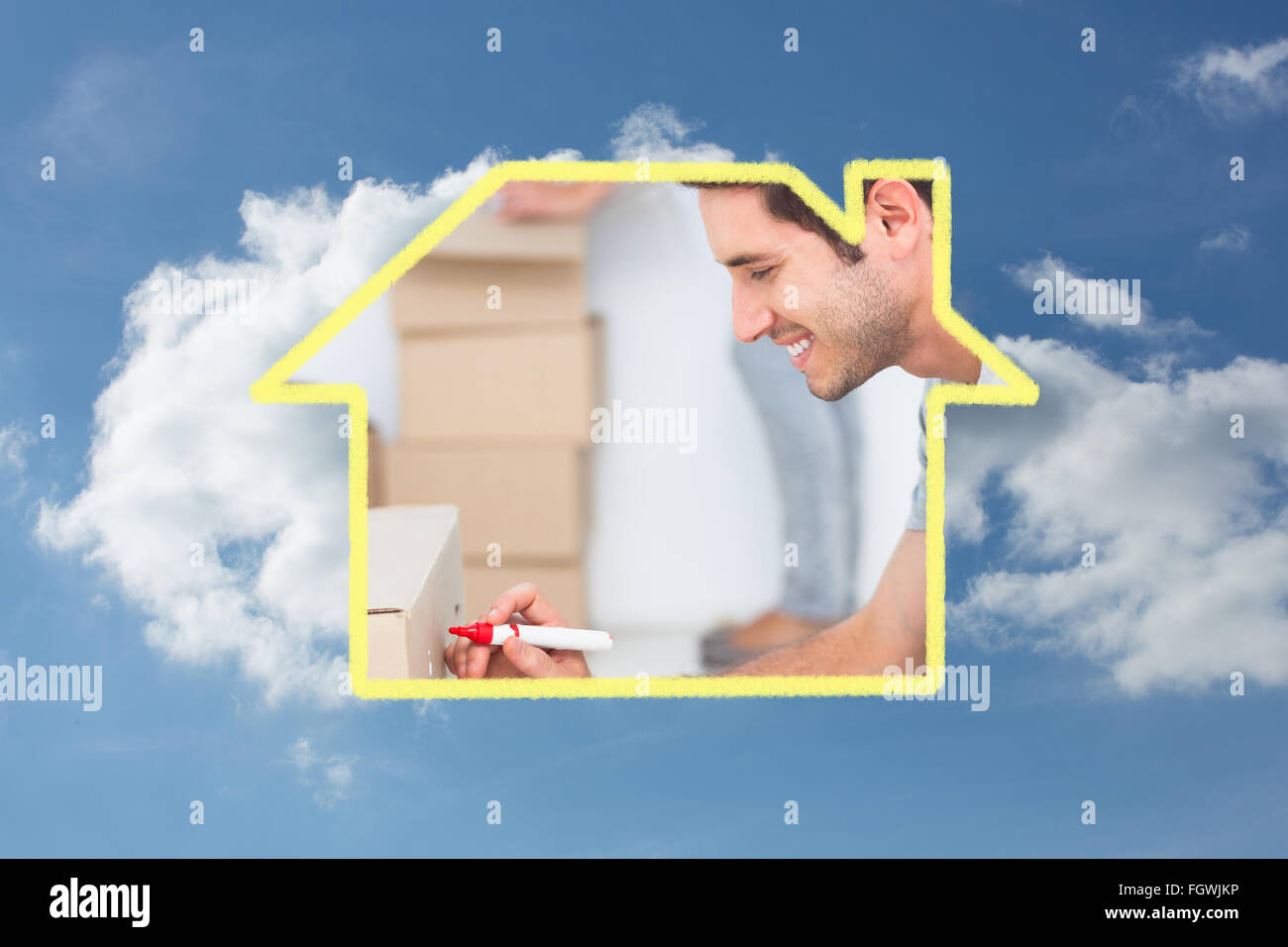 Composite image of man writing withmarker on moving box Stock Photo - Alamy