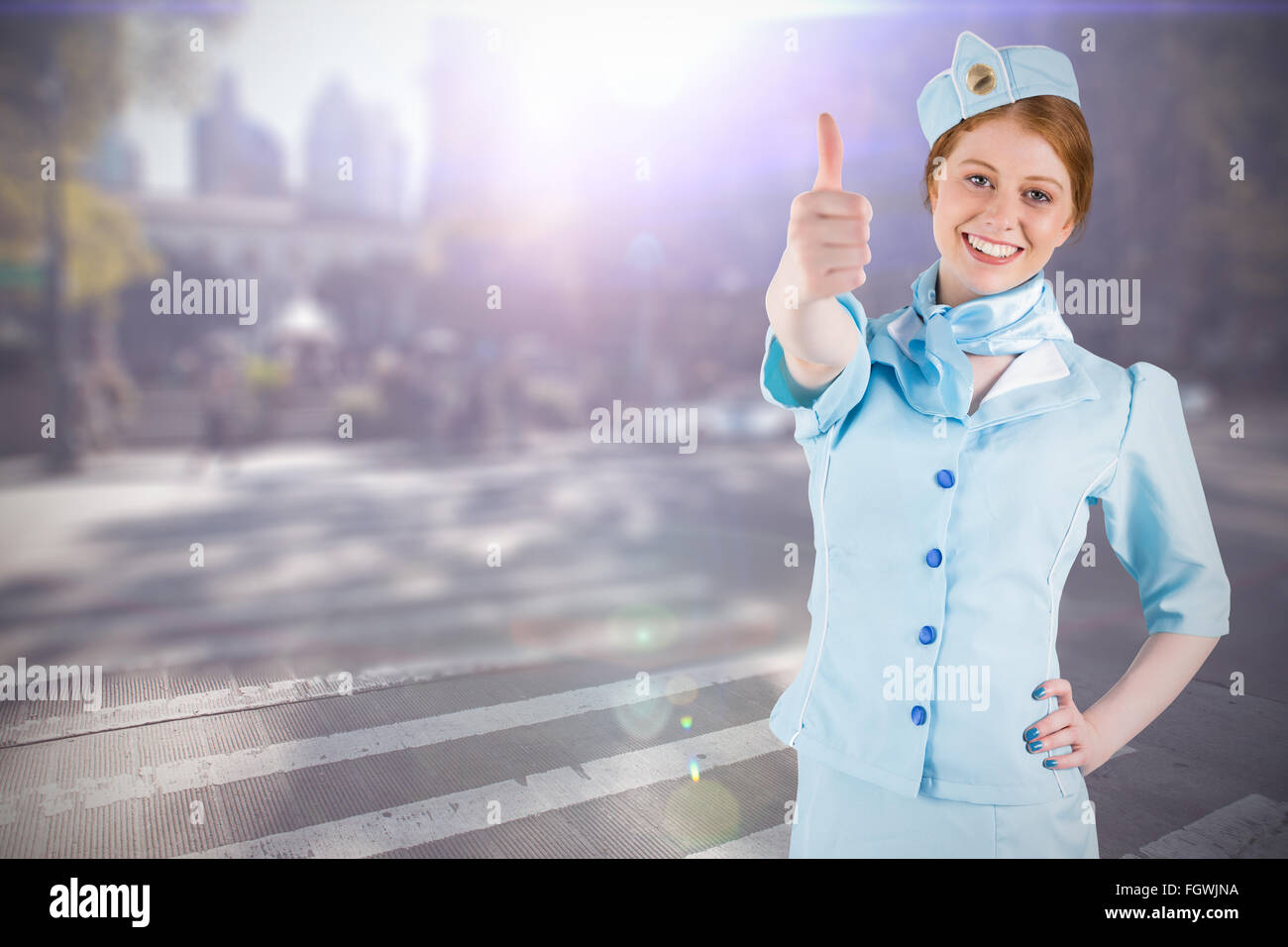 Composite image of pretty air hostess with hand on hip Stock Photo
