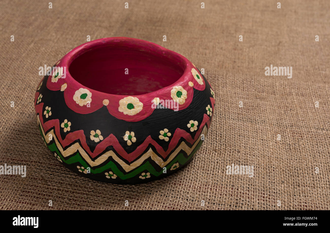 Angled view of a colorful Egyptian handcrafted artistic pottery bowl on a  sackcloth background Stock Photo - Alamy