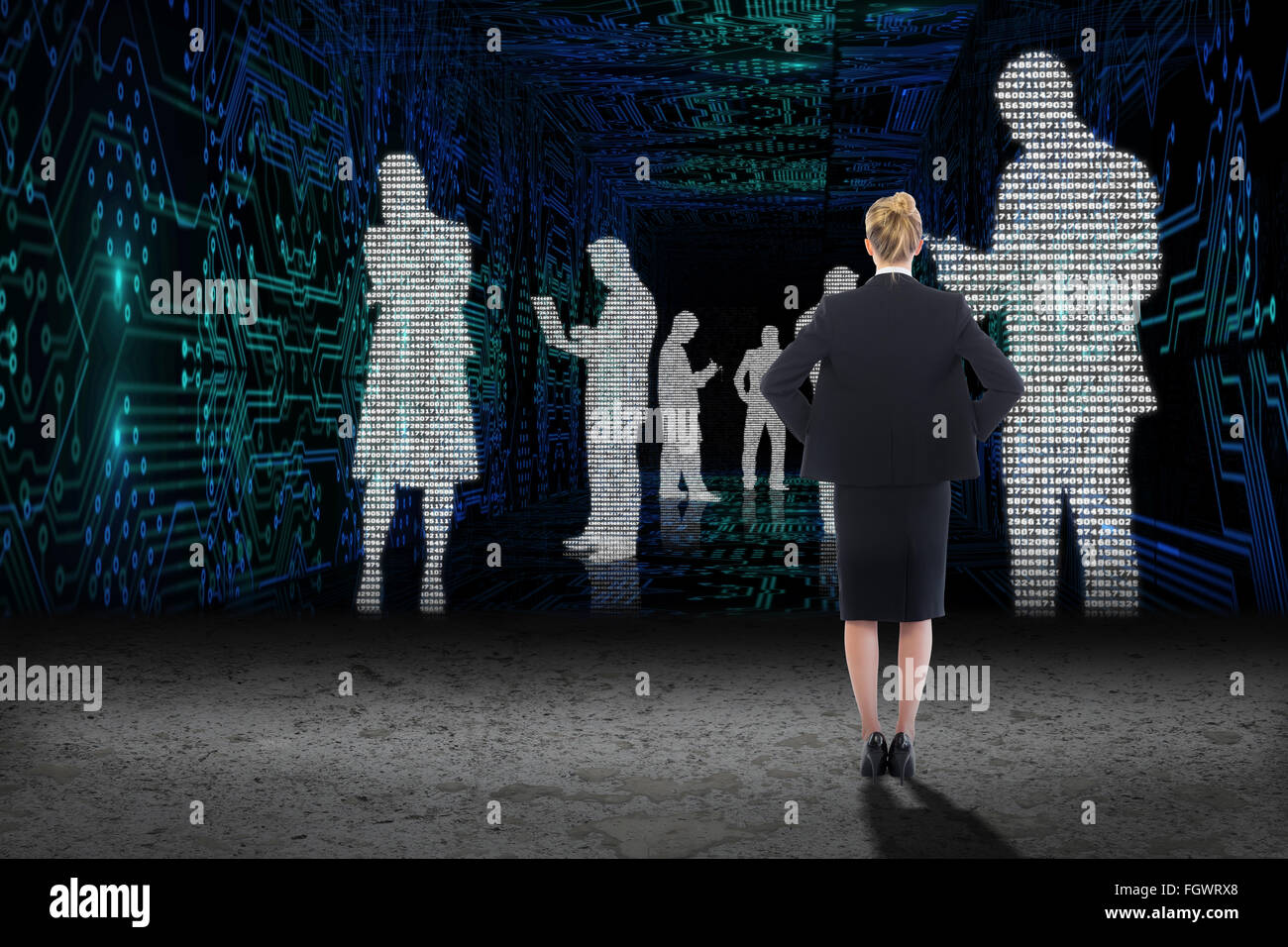 Composite image of businesswoman standing with hands on hips Stock Photo