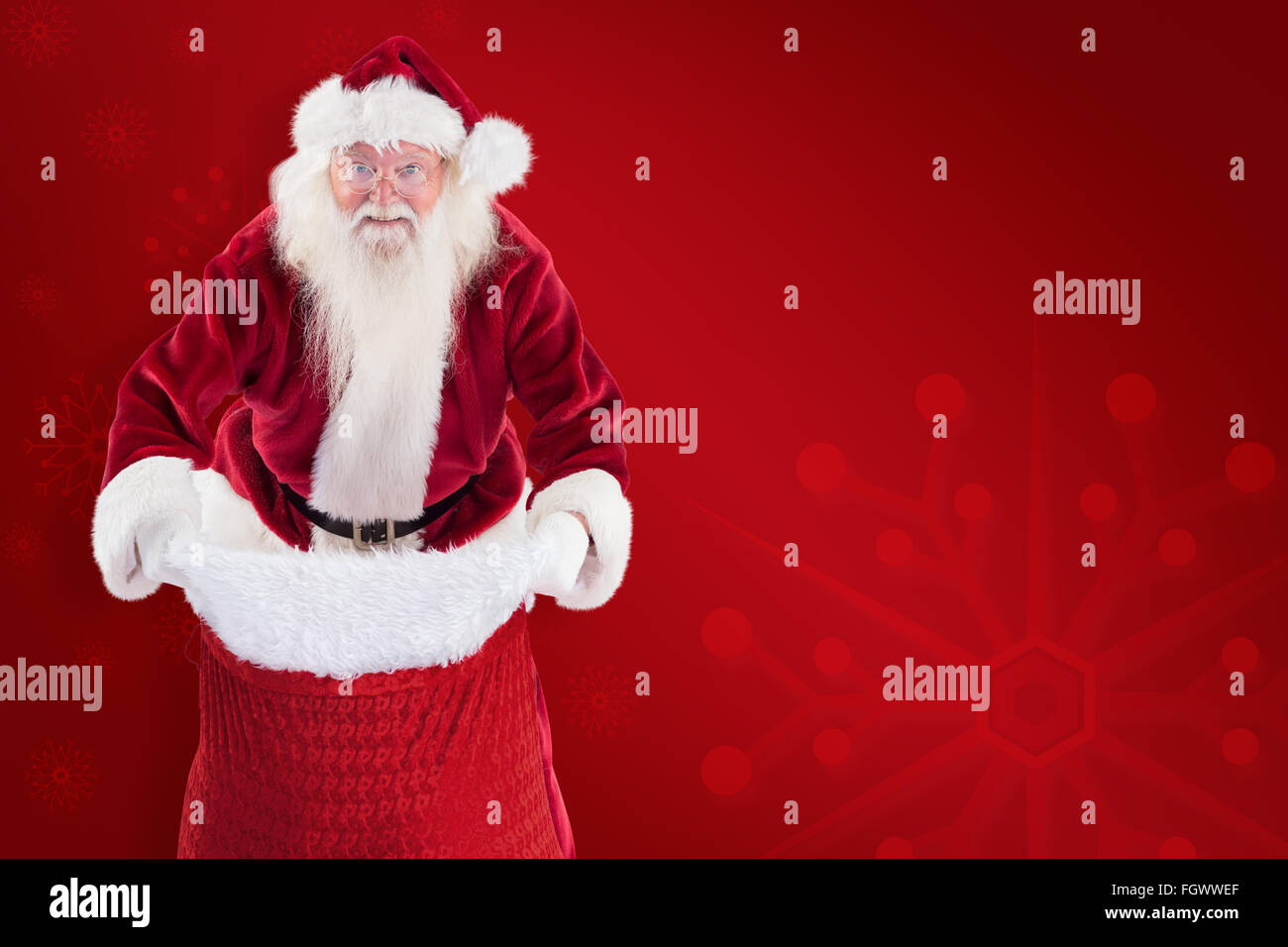 Composite image of santa open his red bag Stock Photo - Alamy