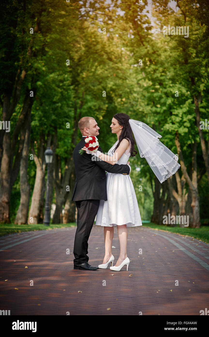 Young couple walking together hand by hand  in summer park Stock Photo