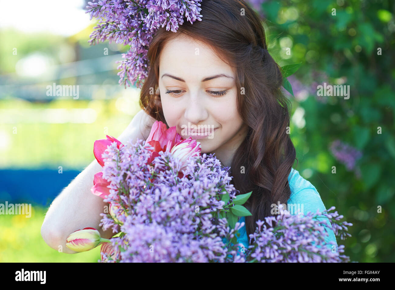 Spring portrait of a beautiful girl with lilac Stock Photo - Alamy
