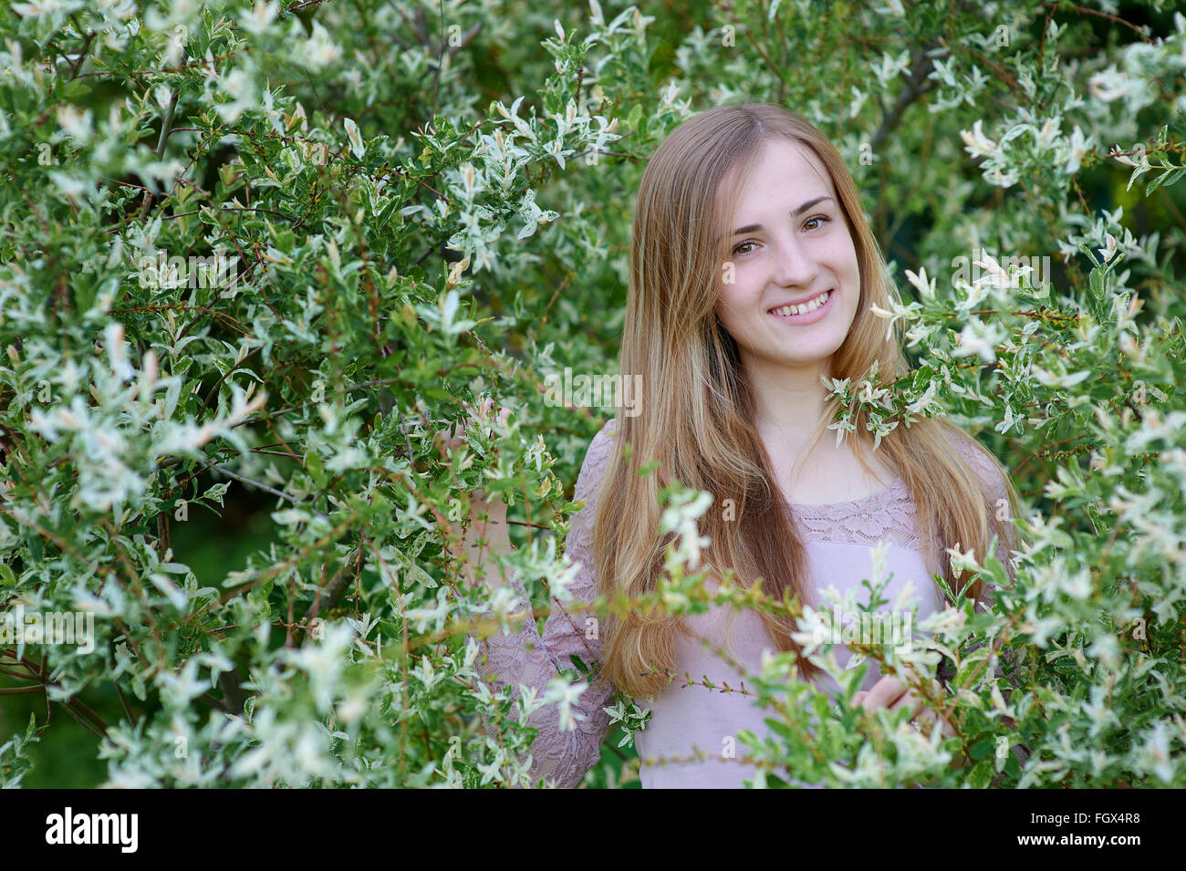 beautiful happy woman in blossoming spring garden on a warm day Stock Photo