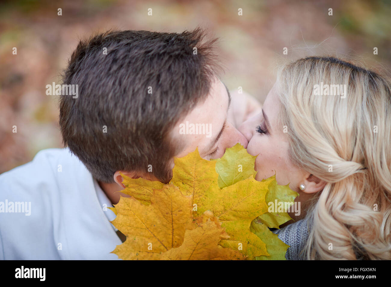 loving couple kissing in autumn park Stock Photo - Alamy