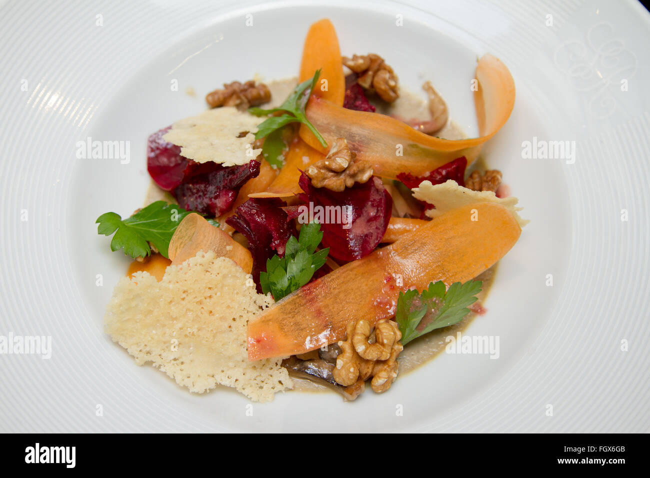 Healthy salad with greens, parmesan and walnuts Stock Photo
