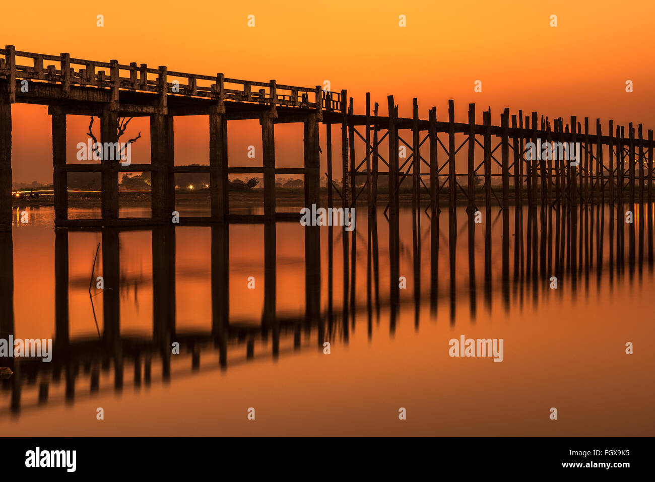 Sunset over the historic wooden U Bein Bridge near Mandalay in Myanmar. Long exposure. Stock Photo