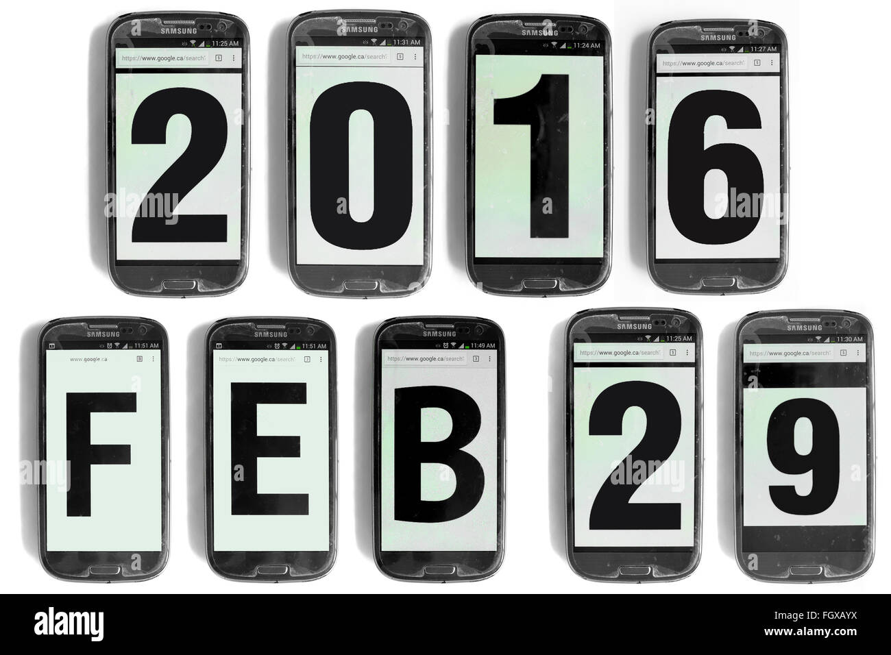 2016 Feb 29 written on the screens of smartphones photographed against a white background. Stock Photo