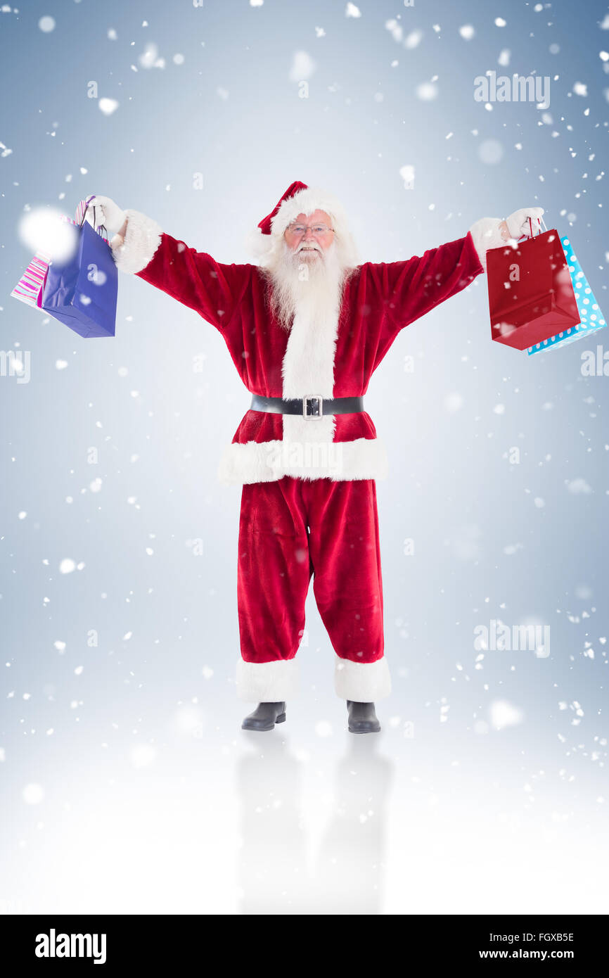 Santa holds some bags for chistmas Stock Photo - Alamy
