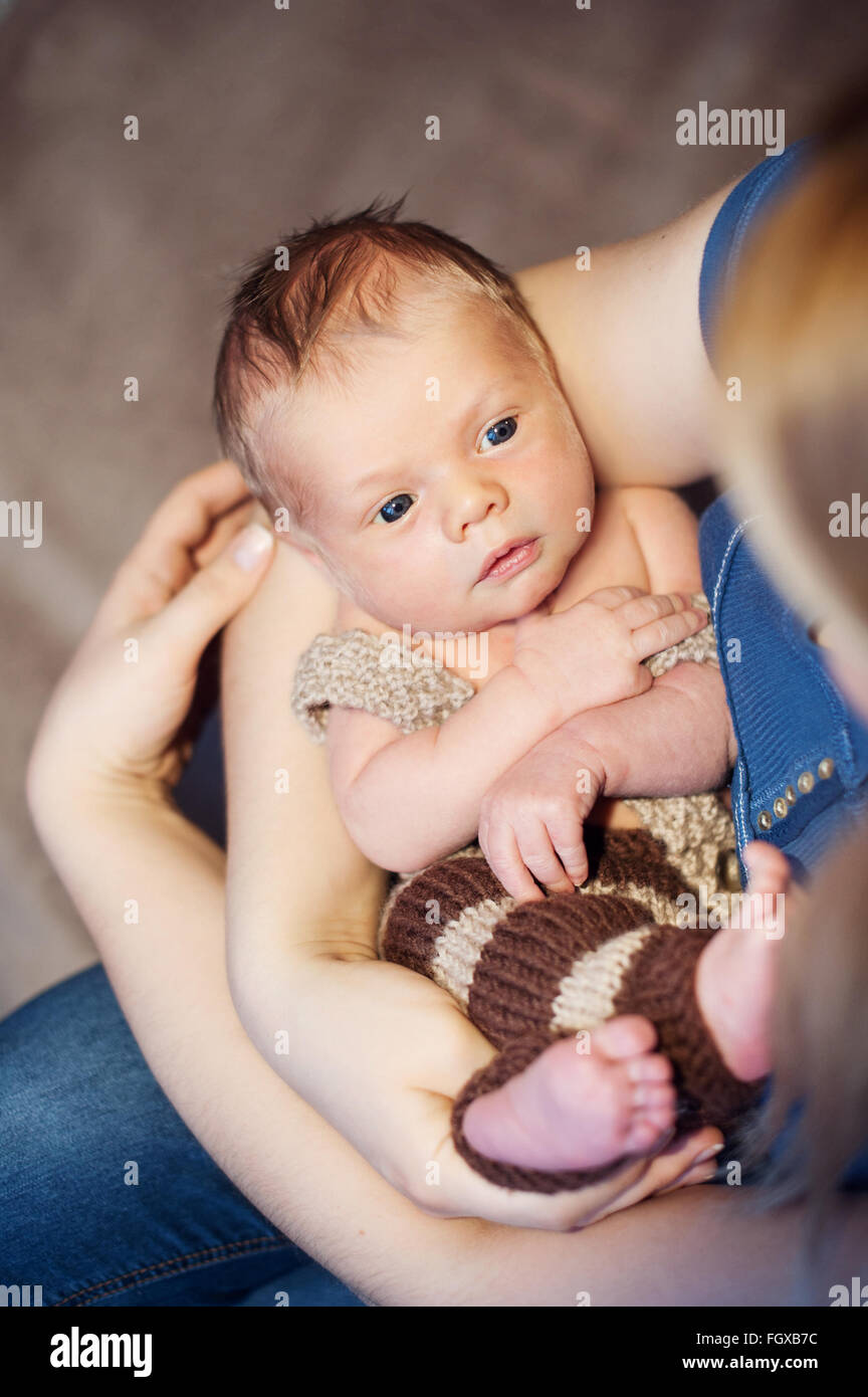 Infant. A woman holds in her arms her newborn baby Stock Photo