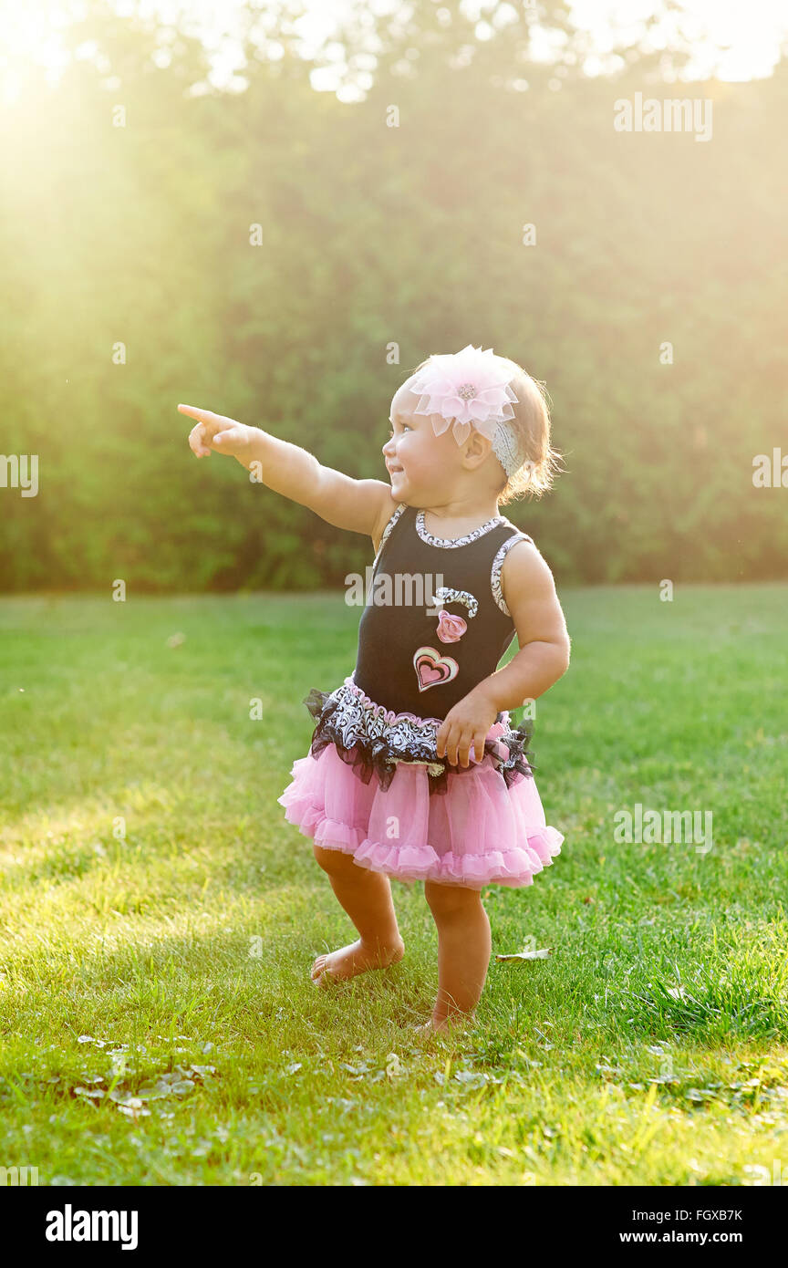 Happy Little girl playing in summer meadow on grass Stock Photo - Alamy