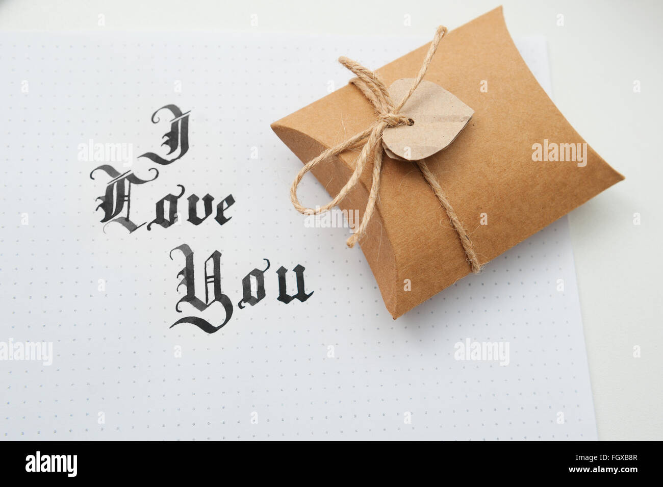 Text god bless you on paper texture and gift box with heart Stock Photo