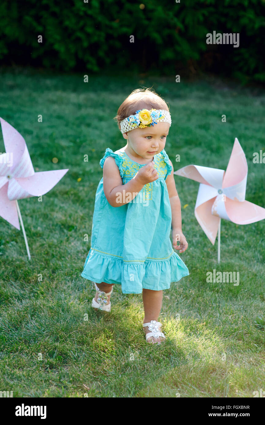 Little girl playing on the grass in the summer park Stock Photo - Alamy