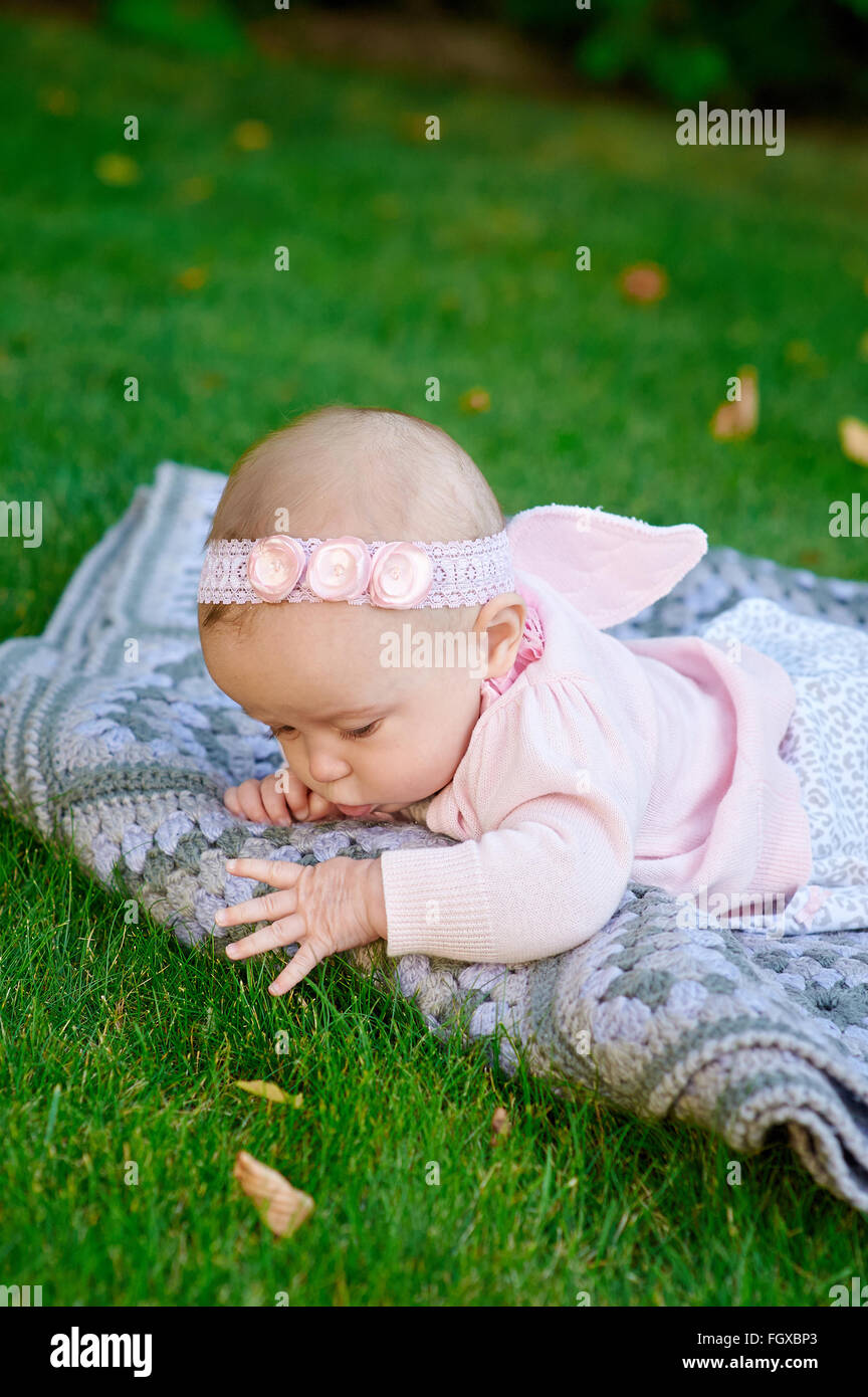 Little girl playing on the grass in the summer park Stock Photo - Alamy