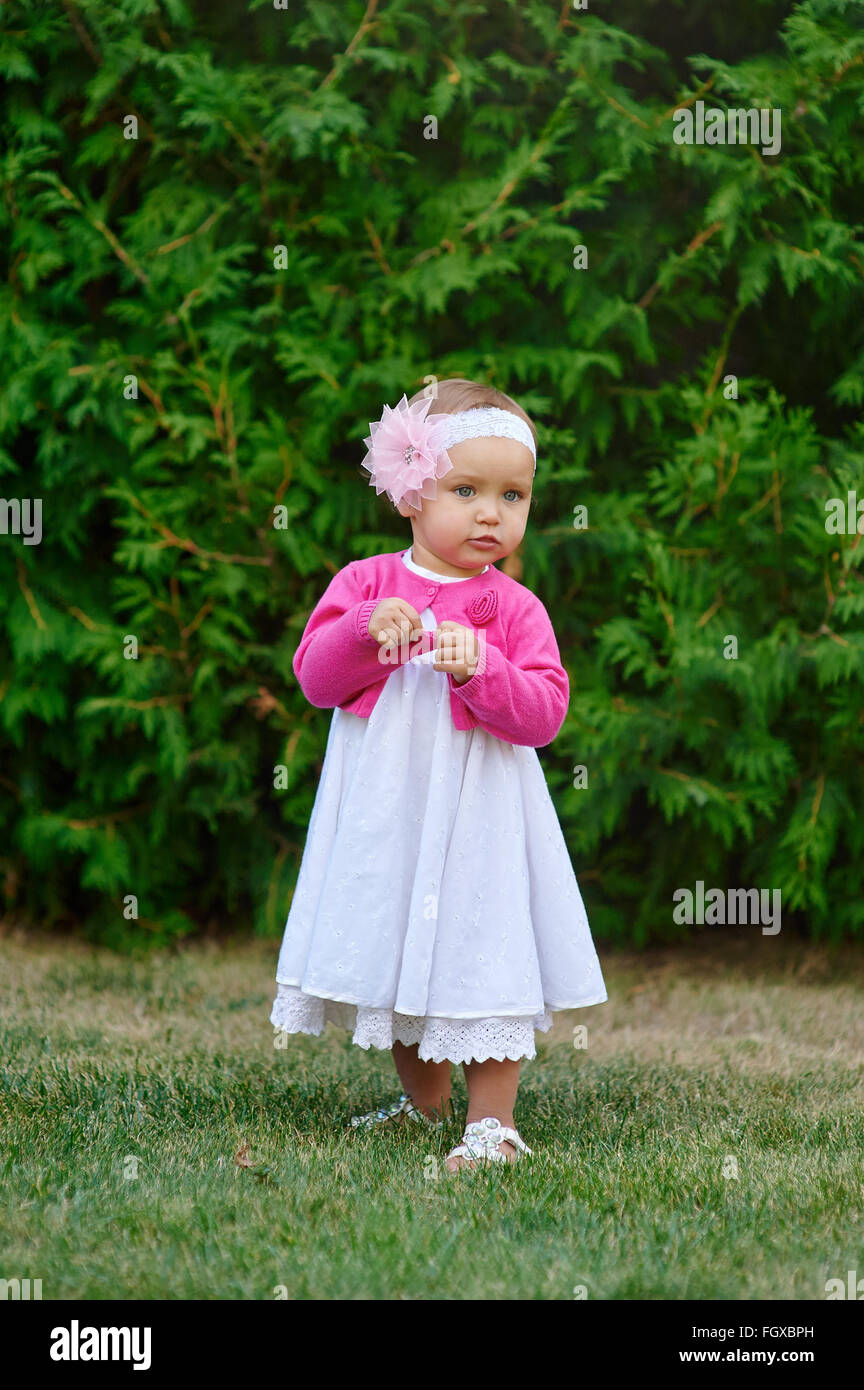 Little girl playing on the grass in the summer park Stock Photo - Alamy