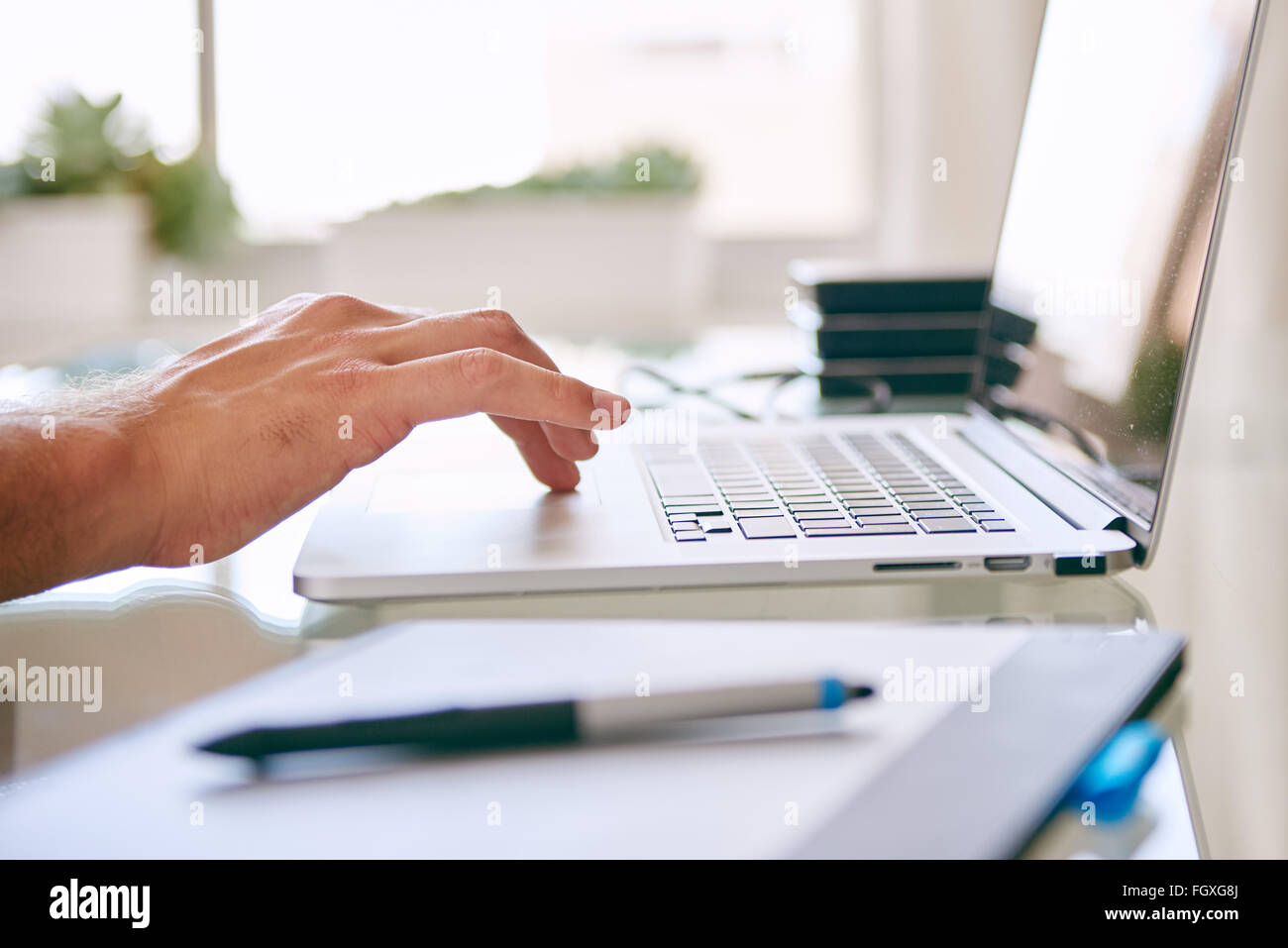 Hand busy operating the touchpad on a notebook Stock Photo Alamy