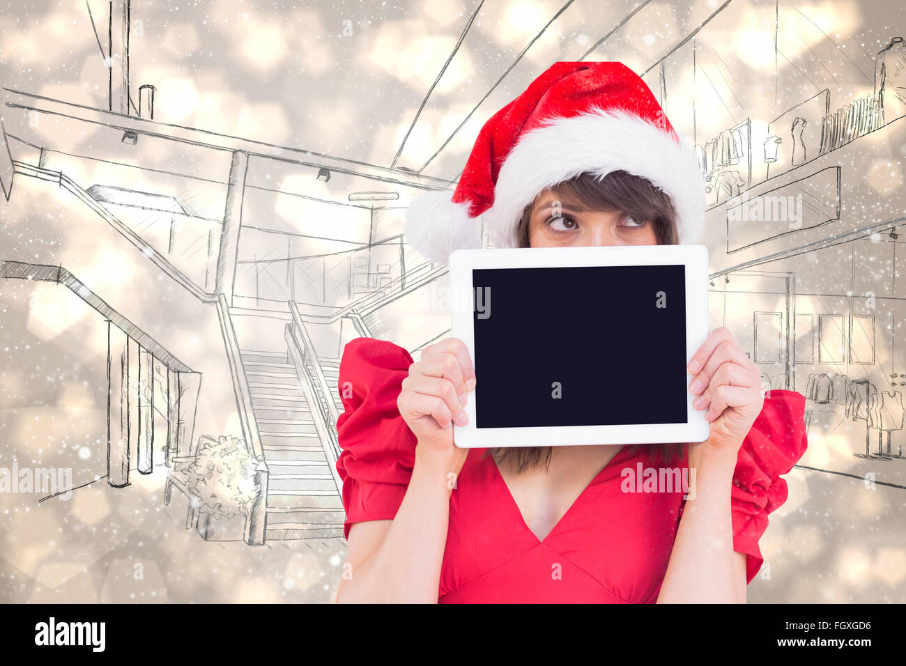Composite image of festive brunette holding a tablet pc Stock Photo