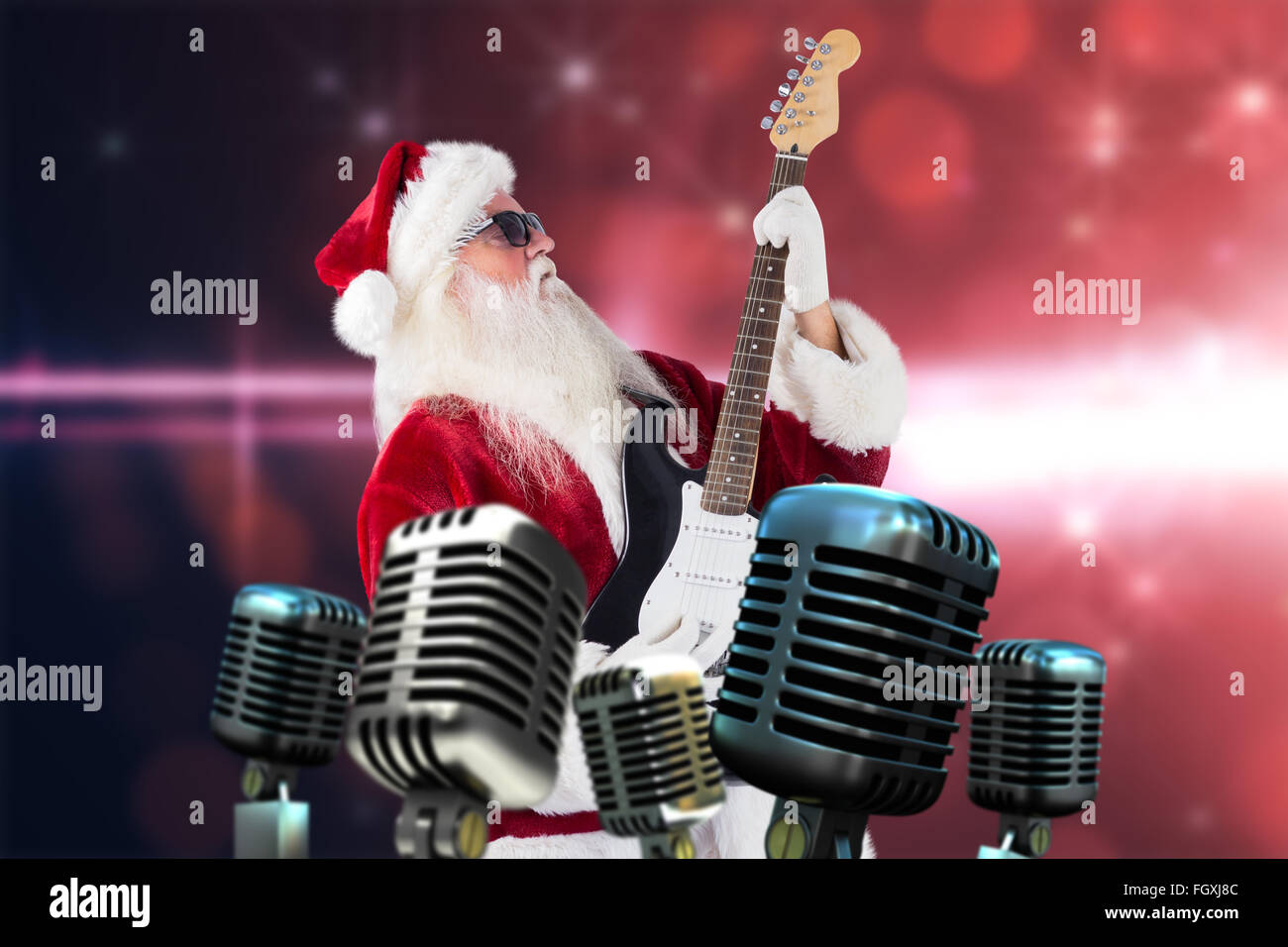 Composite image of santa playing electric guitar Stock Photo