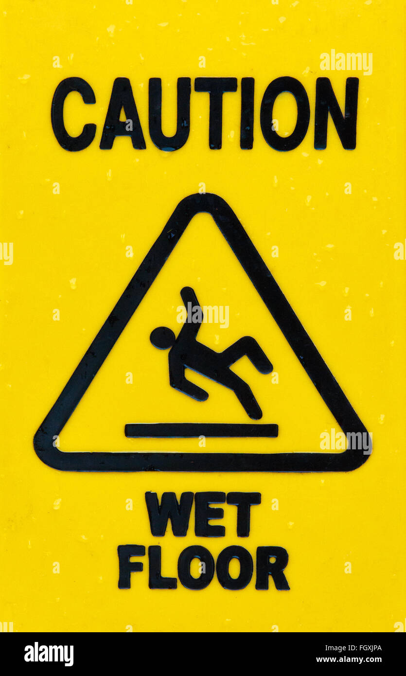 Yellow triangular sign warning for slippery floor when wet Stock Photo