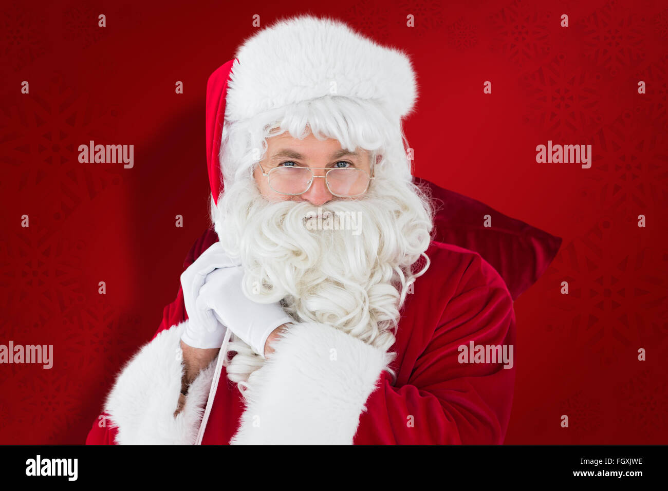 Composite image of happy santa claus holding his sack Stock Photo - Alamy