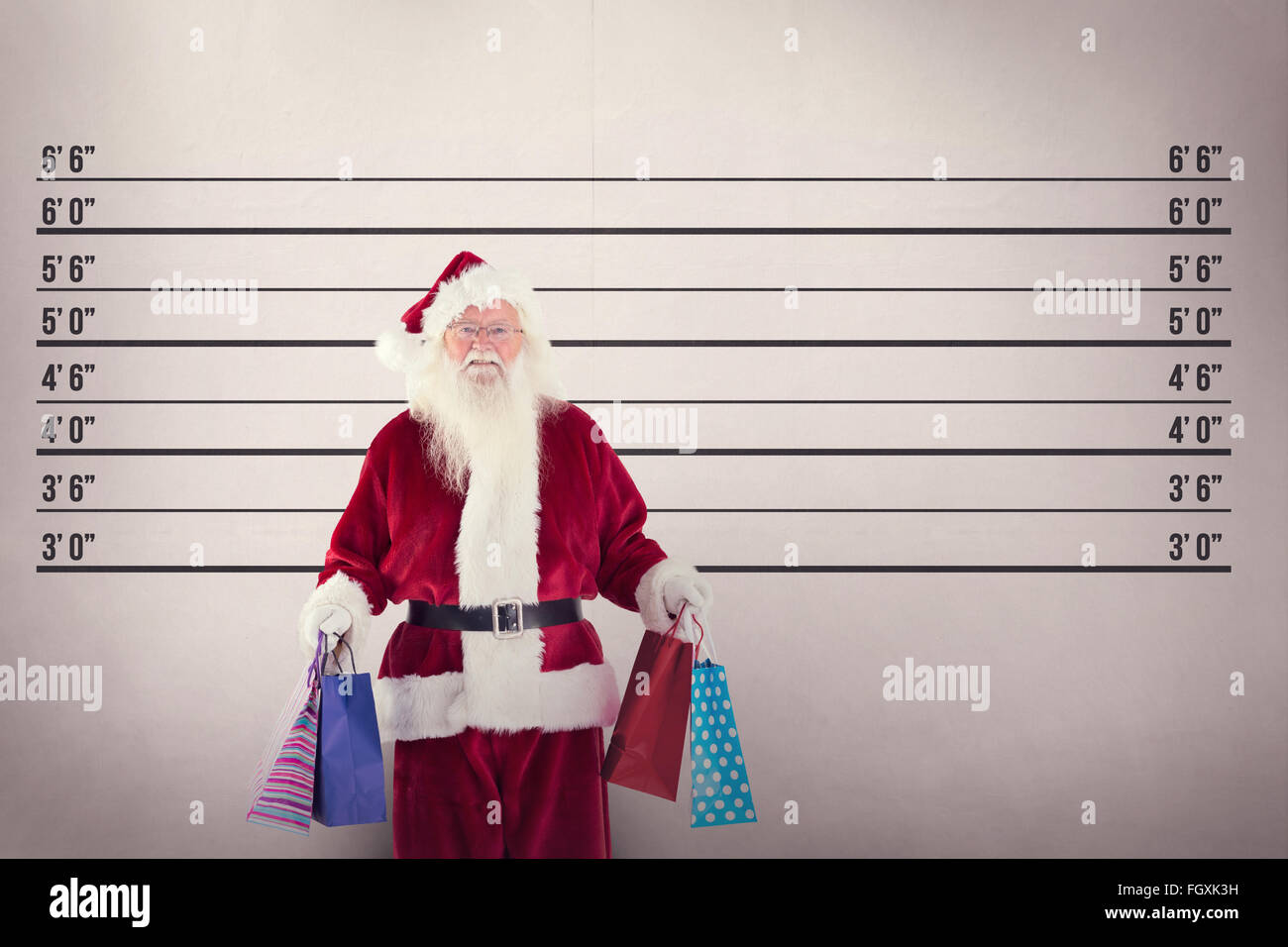 Composite image of santa carries some christmas bags Stock Photo - Alamy